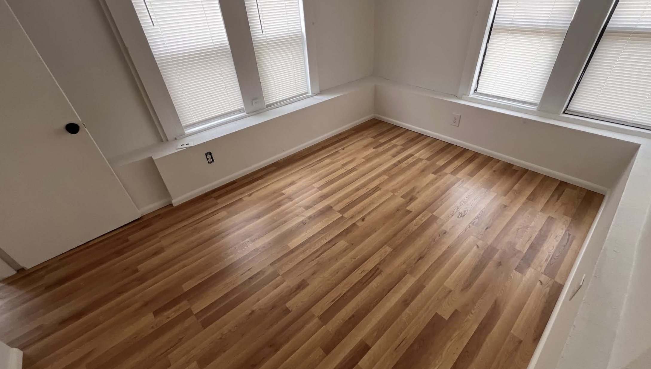 Renovated room with hardwood flooring